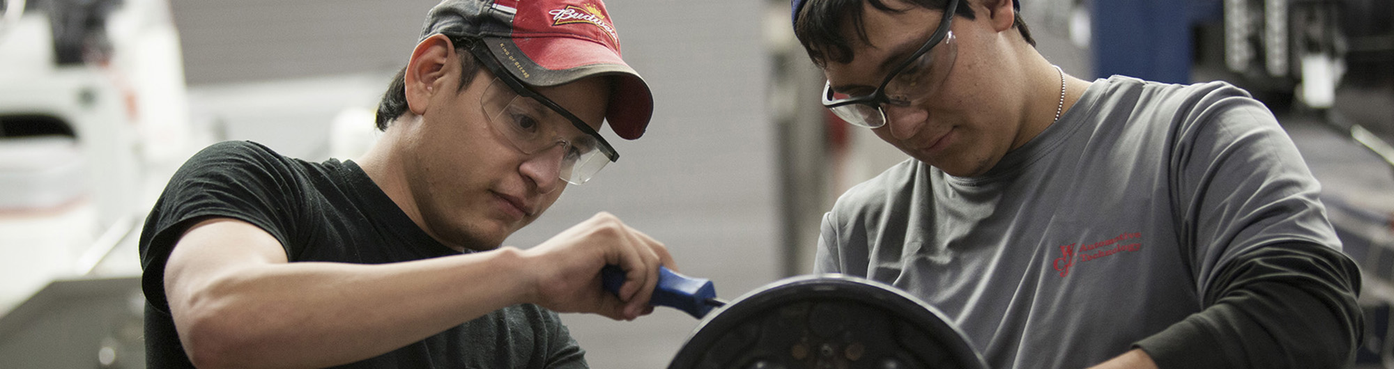 automotive students working on a car